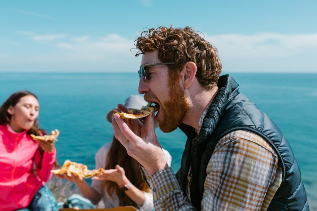 People Eating Pizza Neat Body of Water