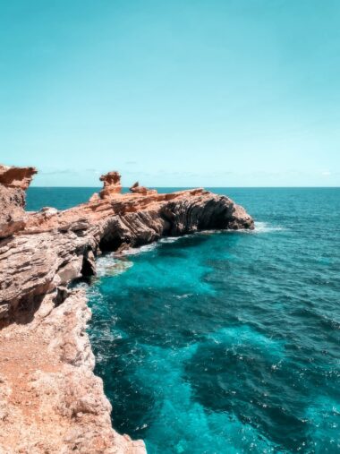 brown rock formation on sea during daytime