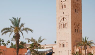 a horse drawn carriage in front of a tall tower