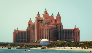 A large building sitting on top of a beach next to the ocean