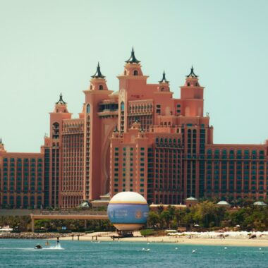 A large building sitting on top of a beach next to the ocean